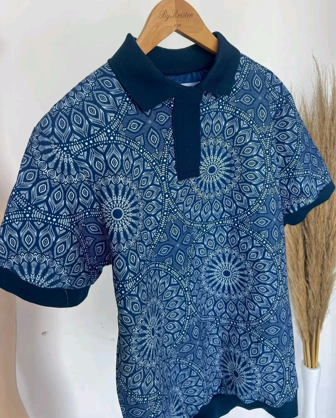 Shweshwe Golf Tshirt in Blue Royal Mandala print on a hanger